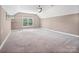 Bedroom featuring neutral carpet, a ceiling fan, and a bright window view at 217 Blossom Hill Rd, Lincolnton, NC 28092