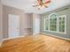 Bedroom with a large arched window, beautiful hardwood floors, and neutral paint at 217 Blossom Hill Rd, Lincolnton, NC 28092