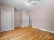 Spacious bedroom boasts hardwood floors, a ceiling fan, closet, and entry doors, offering ample space at 217 Blossom Hill Rd, Lincolnton, NC 28092