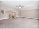 Empty bonus room with neutral carpeting, lighting fixtures, and an open wall concept at 217 Blossom Hill Rd, Lincolnton, NC 28092