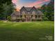 Charming two-story home with a stone facade, inviting front porch, and manicured lawn at 217 Blossom Hill Rd, Lincolnton, NC 28092