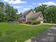 Charming two-story home featuring a lush green lawn, inviting pool, and a spacious deck for outdoor entertaining at 217 Blossom Hill Rd, Lincolnton, NC 28092