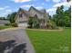 Charming two-story home with a stone facade, attached garage, and manicured lawn at 217 Blossom Hill Rd, Lincolnton, NC 28092