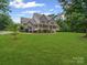 Charming two-story home with a stone facade, inviting front porch, and manicured lawn at 217 Blossom Hill Rd, Lincolnton, NC 28092