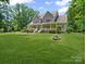 Charming two-story home with a stone facade, inviting front porch, and manicured lawn at 217 Blossom Hill Rd, Lincolnton, NC 28092