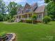 Charming two-story home with a stone facade, inviting front porch, and manicured lawn at 217 Blossom Hill Rd, Lincolnton, NC 28092