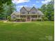 Charming two-story home with a stone facade, inviting front porch, and manicured lawn at 217 Blossom Hill Rd, Lincolnton, NC 28092