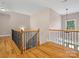 Open hallway with wood banister and hardwood flooring at 217 Blossom Hill Rd, Lincolnton, NC 28092