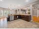 Open-concept kitchen featuring stainless steel appliances, granite countertops, and hardwood floors at 217 Blossom Hill Rd, Lincolnton, NC 28092