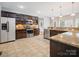 Well-appointed kitchen featuring dark wood cabinetry, stainless steel appliances, and granite countertops, offering modern convenience and style at 217 Blossom Hill Rd, Lincolnton, NC 28092