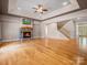 Bright and airy living room with stone fireplace, tray ceiling, and hardwood floors, perfect for relaxation and entertaining at 217 Blossom Hill Rd, Lincolnton, NC 28092