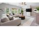 Living room area offering large windows, neutral furniture, and a ceiling fan at 217 Blossom Hill Rd, Lincolnton, NC 28092