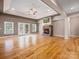 Spacious living room with stone fireplace, hardwood floors, and ample natural light, creating a welcoming atmosphere at 217 Blossom Hill Rd, Lincolnton, NC 28092