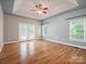 Spacious main bedroom with hardwood floors, large windows, and tray ceiling at 217 Blossom Hill Rd, Lincolnton, NC 28092