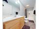 Bathroom featuring a light wood vanity with a white sink, and a shower with gray tile floors at 22970 Lake Tillery Rd, Albemarle, NC 28001