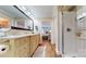 Well-lit bathroom featuring double vanities and a glass door shower, providing a spa-like experience at 22970 Lake Tillery Rd, Albemarle, NC 28001