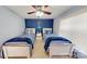 Charming bedroom with two twin beds, nautical decor, a ceiling fan, and natural light from the window at 22970 Lake Tillery Rd, Albemarle, NC 28001