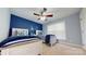 Charming bedroom with two twin beds, nautical decor, a ceiling fan, and natural light from the window at 22970 Lake Tillery Rd, Albemarle, NC 28001