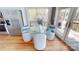 Cozy dining area featuring a glass-top table with views of the outdoors, hardwood floors and modern stainless steel refrigerator at 22970 Lake Tillery Rd, Albemarle, NC 28001