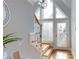 Welcoming entryway with stylish staircase, decorative mirror, and ample natural light from the large, modern windows at 22970 Lake Tillery Rd, Albemarle, NC 28001