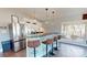 Kitchen with glass bar counter and three stools, next to stainless steel appliances, and view of the outdoors at 22970 Lake Tillery Rd, Albemarle, NC 28001