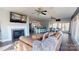 Open-concept living area with tile flooring, a fireplace, a flat screen television and a living room with a modern kitchen at 22970 Lake Tillery Rd, Albemarle, NC 28001