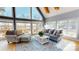 Bright living room featuring a comfortable seating area, large windows, and hardwood floors at 22970 Lake Tillery Rd, Albemarle, NC 28001