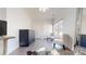 Bright, airy living room with tile flooring, closet, two chairs and large mirror, bathed in natural light at 22970 Lake Tillery Rd, Albemarle, NC 28001