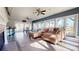 Spacious living room with tiled floors, a comfortable leather sofa, large windows and access to outdoor patio at 22970 Lake Tillery Rd, Albemarle, NC 28001