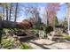 Relax in this backyard, which includes a water feature, landscaping, and patio furniture at 2620 Merion Hills Ct, Charlotte, NC 28269