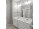 Bathroom features a double sink vanity with a large mirror and vanity lighting at 2620 Merion Hills Ct, Charlotte, NC 28269