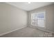 Bedroom features carpeted floors, natural light, and neutral paint at 2620 Merion Hills Ct, Charlotte, NC 28269