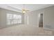 Spacious bedroom with a ceiling fan, large window, and ensuite bathroom at 2620 Merion Hills Ct, Charlotte, NC 28269