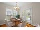 Dining area with hardwood floors, large windows, and a stylish round table at 2620 Merion Hills Ct, Charlotte, NC 28269