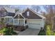 Charming home features a two-car garage, cozy front porch, and manicured lawn at 2620 Merion Hills Ct, Charlotte, NC 28269