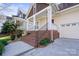 Home featuring brick steps leading to a cozy covered front porch at 2620 Merion Hills Ct, Charlotte, NC 28269