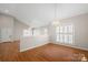 Open living area features hardwood floors, natural light, and neutral paint at 2620 Merion Hills Ct, Charlotte, NC 28269