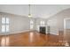 Spacious living room with hardwood floors and a cozy fireplace at 2620 Merion Hills Ct, Charlotte, NC 28269