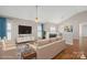 Cozy living room featuring a fireplace, hardwood floors, and comfortable seating at 2620 Merion Hills Ct, Charlotte, NC 28269