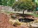Backyard pond with natural waterfall feature and rock landscaping at 2620 Merion Hills Ct, Charlotte, NC 28269