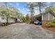 Spacious backyard, including a carport, patio, and mature trees at 27 Heritage Ct, Lake Wylie, SC 29710