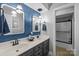 Updated bathroom with double vanity, framed mirrors, modern lighting fixtures, wainscoting and designer paint at 27 Heritage Ct, Lake Wylie, SC 29710