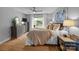 Bright bedroom featuring a ceiling fan, wood floors, and sliding glass doors to the outside at 27 Heritage Ct, Lake Wylie, SC 29710