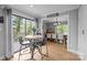 Cozy breakfast nook with a round table, large windows, and hardwood floors, offering a charming dining space at 27 Heritage Ct, Lake Wylie, SC 29710