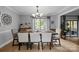 Elegant dining room with hardwood floors, chandelier lighting, and a large window overlooking the greenery at 27 Heritage Ct, Lake Wylie, SC 29710