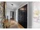 Welcoming entryway featuring a stone accent wall, wood floors, and a stylish double door at 27 Heritage Ct, Lake Wylie, SC 29710