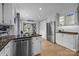 Well-lit kitchen showcasing stainless steel appliances, granite countertops, and hardwood flooring at 27 Heritage Ct, Lake Wylie, SC 29710