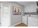 Functional laundry area featuring a washer, dryer, storage cabinets and stylish artwork with a nature theme at 27 Heritage Ct, Lake Wylie, SC 29710
