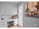 Bright laundry room with white cabinets, folding counter, natural light, and a decorative painting at 27 Heritage Ct, Lake Wylie, SC 29710