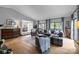 Bright living room with hardwood floors, a comfortable seating arrangement, and an open flow to the dining area at 27 Heritage Ct, Lake Wylie, SC 29710